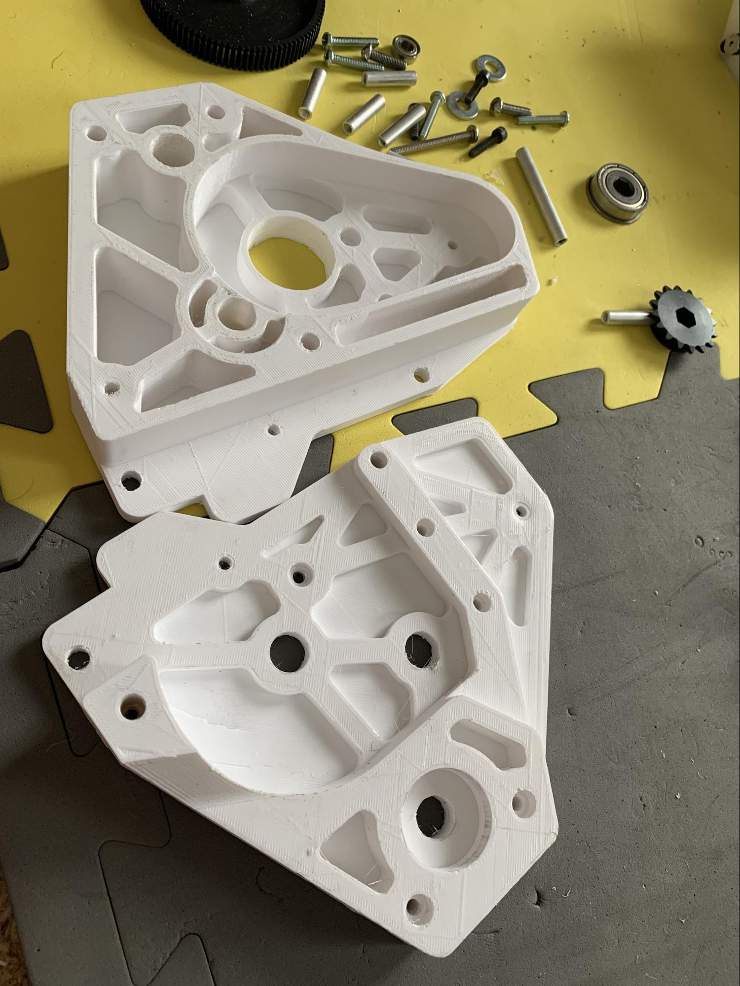 A 3D printed gearbox, printed in 2 parts, cut along a plane